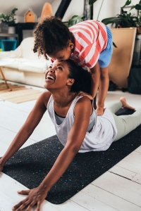 woman doing yoga with her child after hernia repair