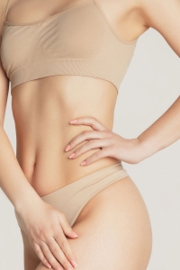 sexy woman's midriff without scars after surgery by hernia doctor